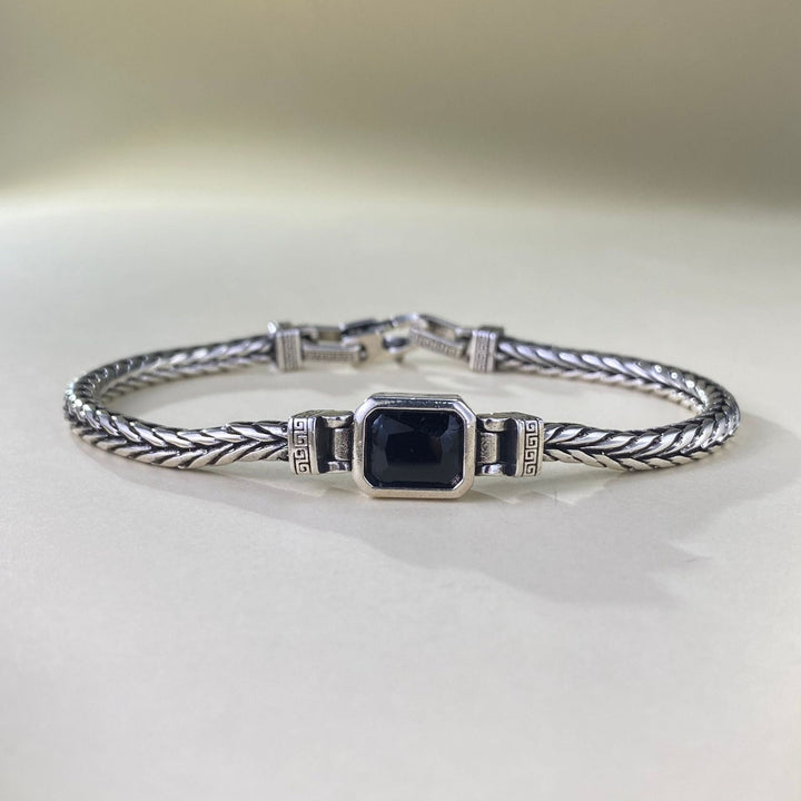 Armband heren | Stalen armband met zwarte steen en gevlochten design