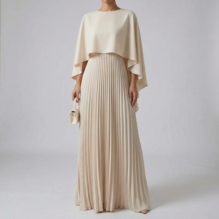 Maxi jurk met plissé rok en cape-overlay – elegant & vloeiend